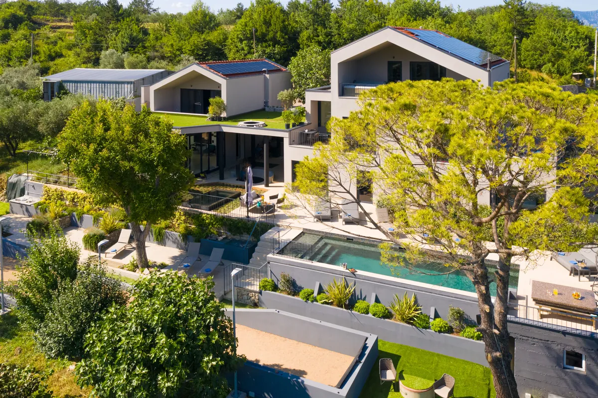 Casa Meline aerial view — full estate with pool, gardens and villa buildings on Krk