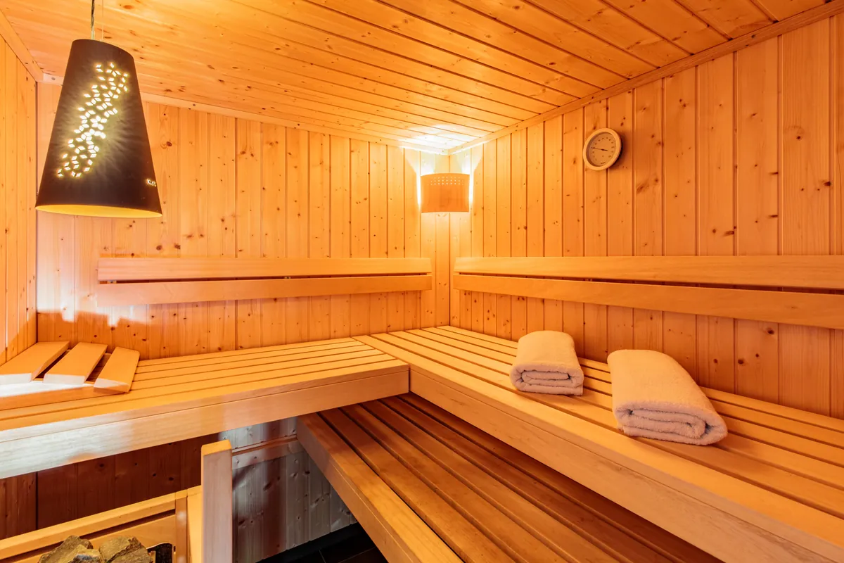 Casa Meline Finnish sauna — cedar interior with ambient lighting and fresh towels