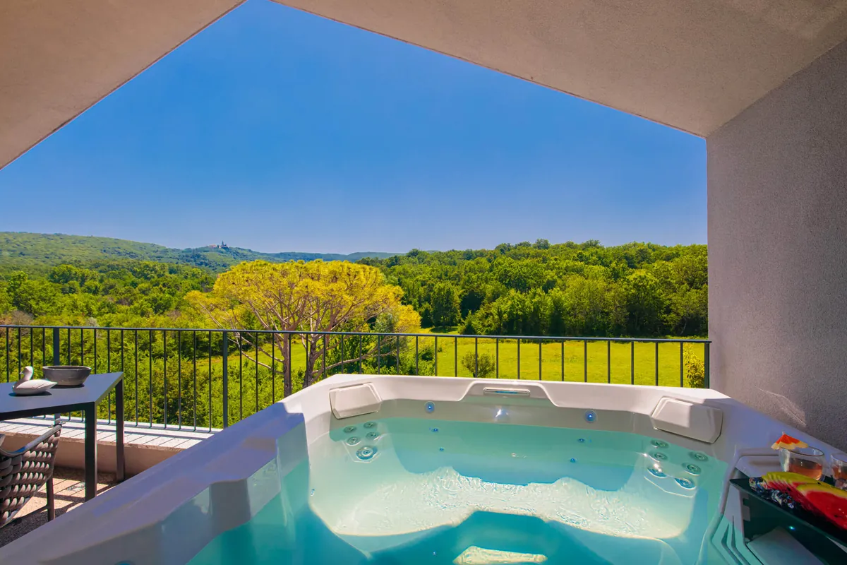 Private terrace jacuzzi with panoramic view of Krk island hills and countryside